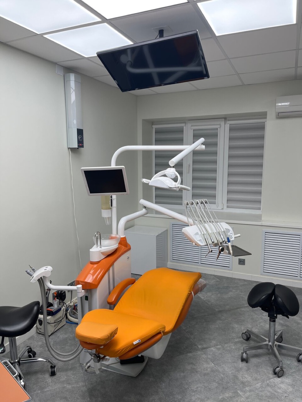 Стоматологический кабинет клиники Estetica с оранжевым креслом